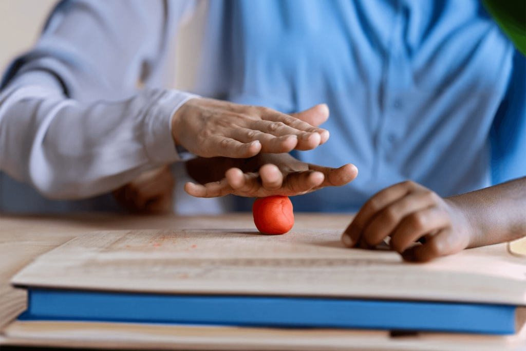 Child doing occupational therapy hand exercise