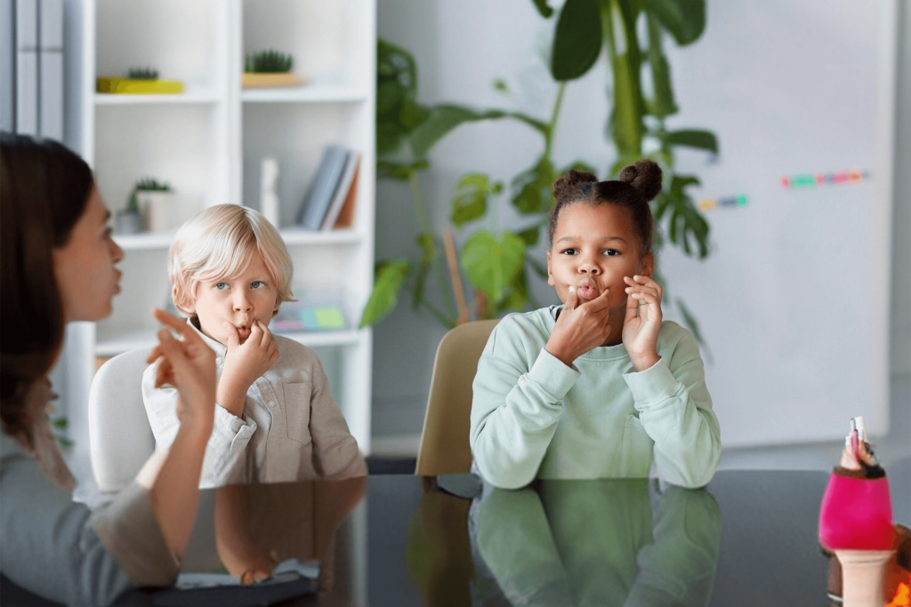 Child practicing speech therapy with therapist