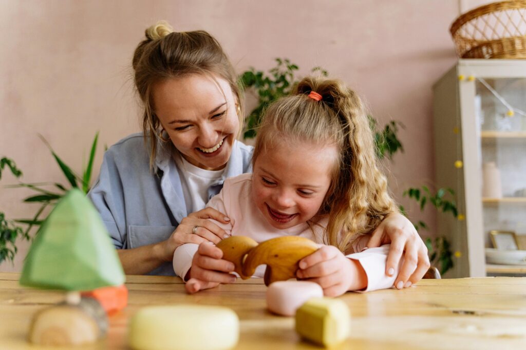 Teacher helping girl with special education activity